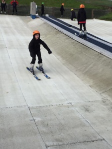 Young skier coming down ski slope at ASN snowsports session