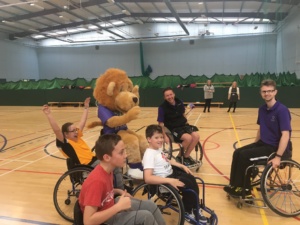 Mascot Leaping Leo joins in Wheelchair Basketball with some of the pupils and coaches