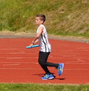 Cameron Adam in relay race with baton