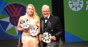 Sammi and Richard on stage with their awards