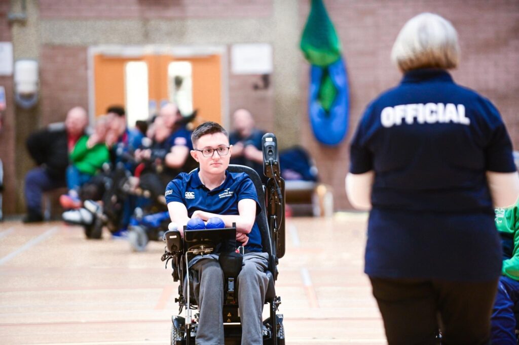 Photo of Alex Medley on the boccia court, looking at the officials. 