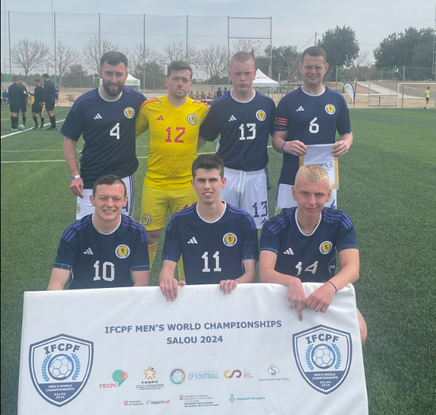 Scotland-players-smile-for-team-photo-behind-a-IFCPF-World-Champs-banner